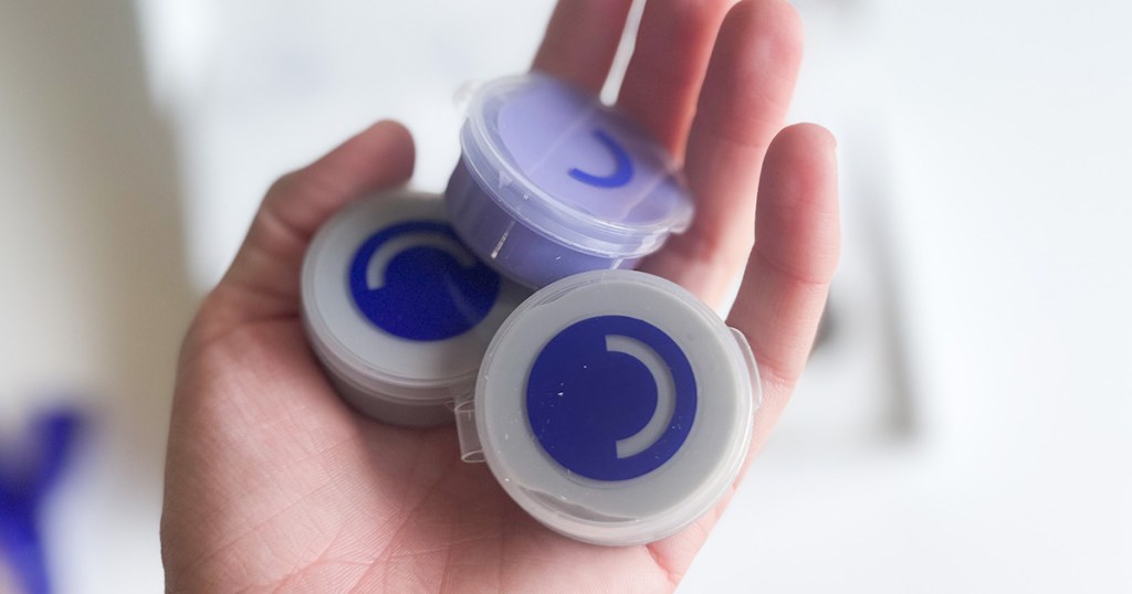 hand holding purple putty from smile direct club