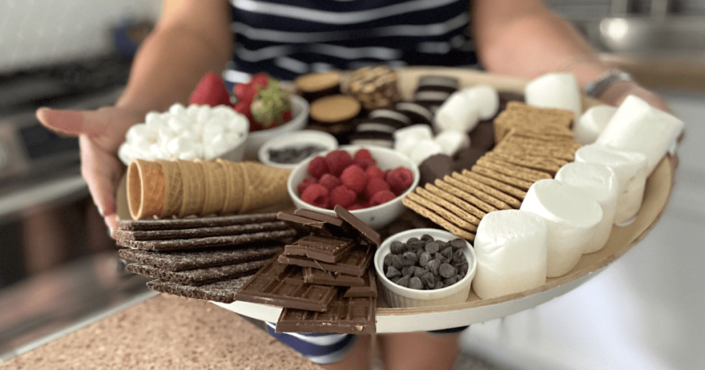 holding up S'mores charcuterie board