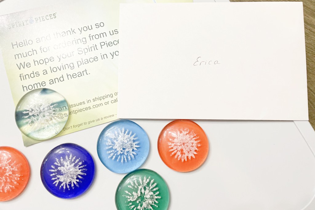 cremation jewelry sharing stones with letter in background