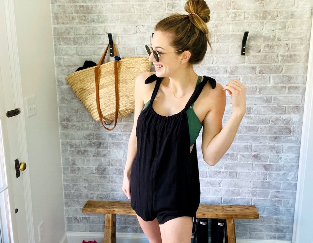 woman smiling wearing black romper bathing suit