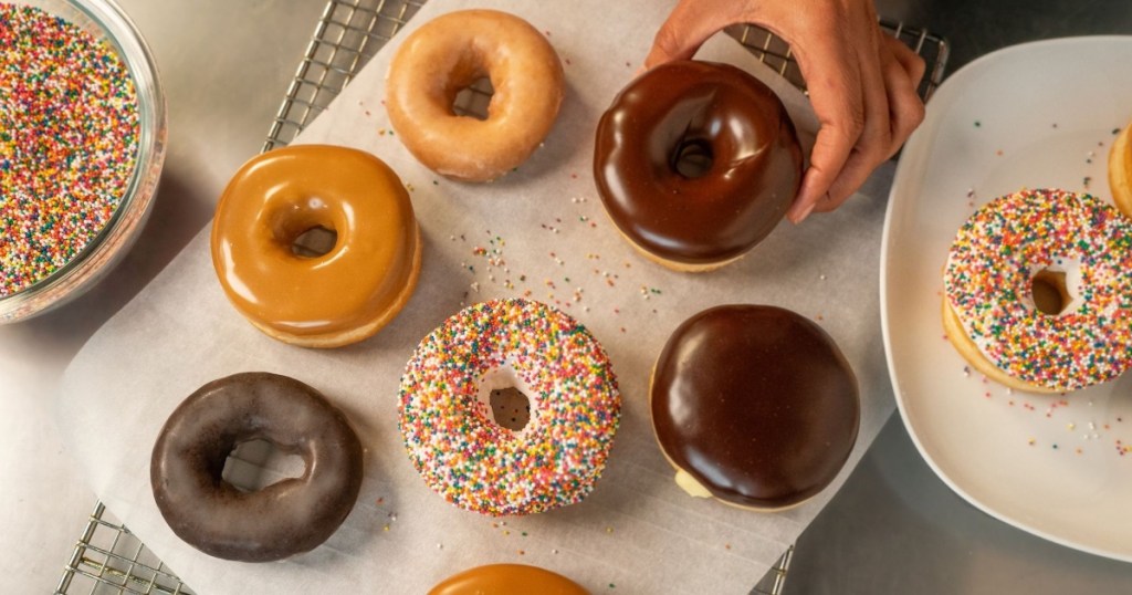 hand choosing a donut from an assortment