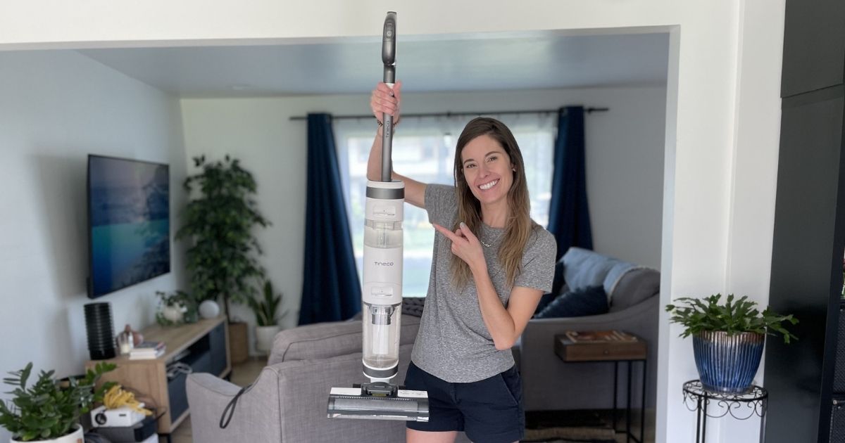 woman holding up vacuum