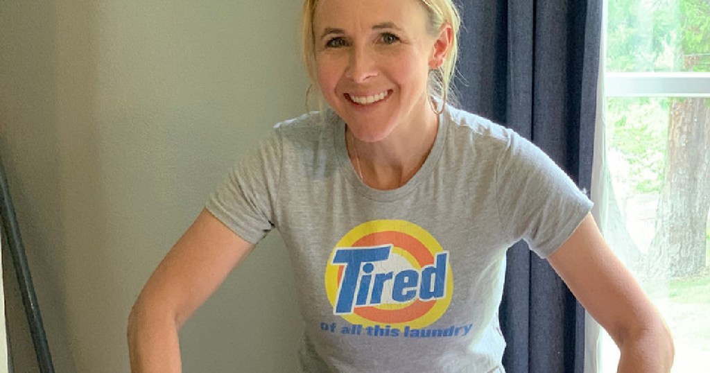 woman wearing a shirt that says tired of all this laundry on the front