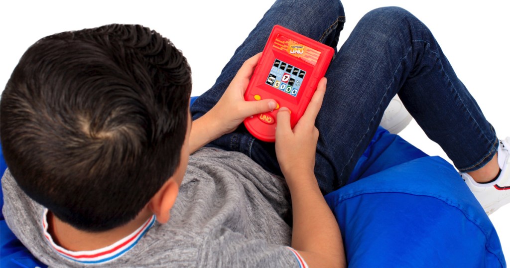 Kid playing uno handheld game