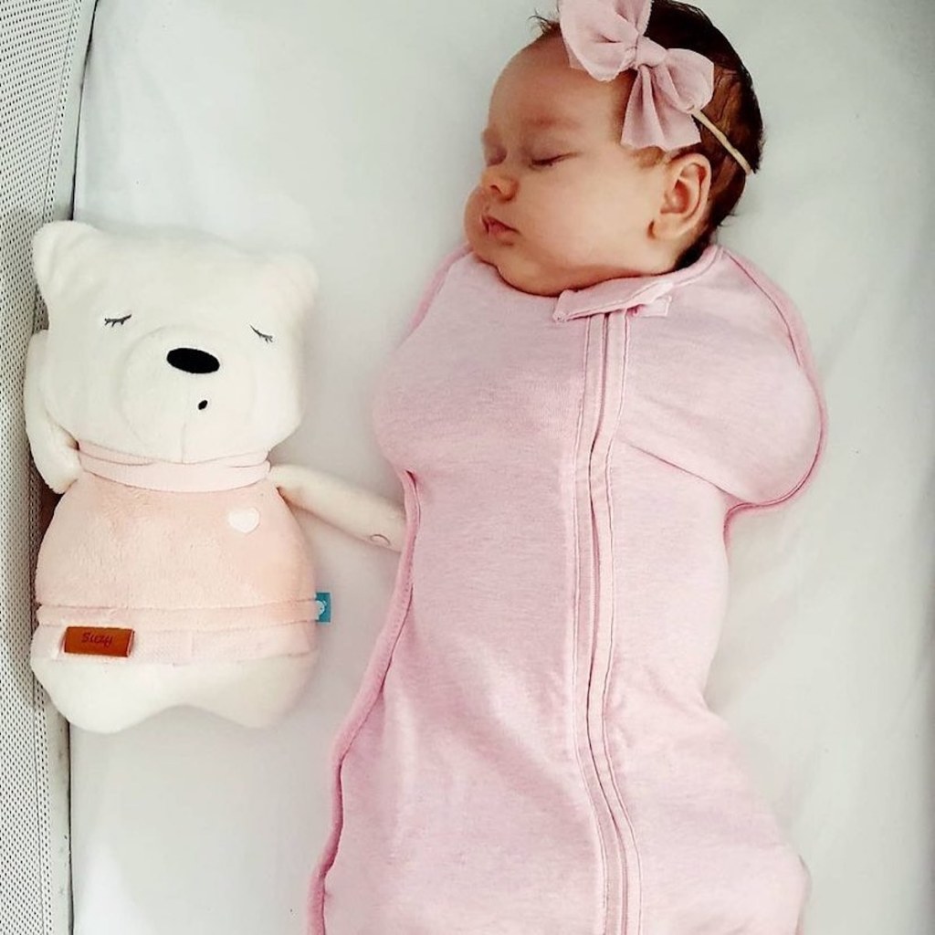 baby wearing pink swaddle while sleeping