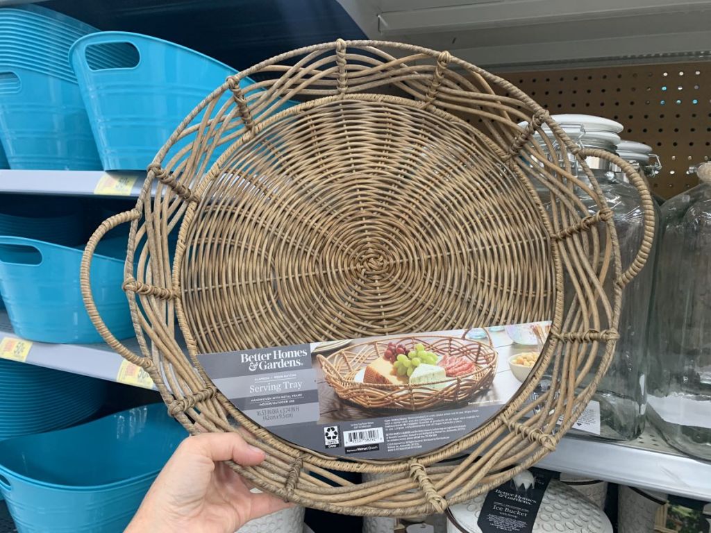 hand holding a round serving tray