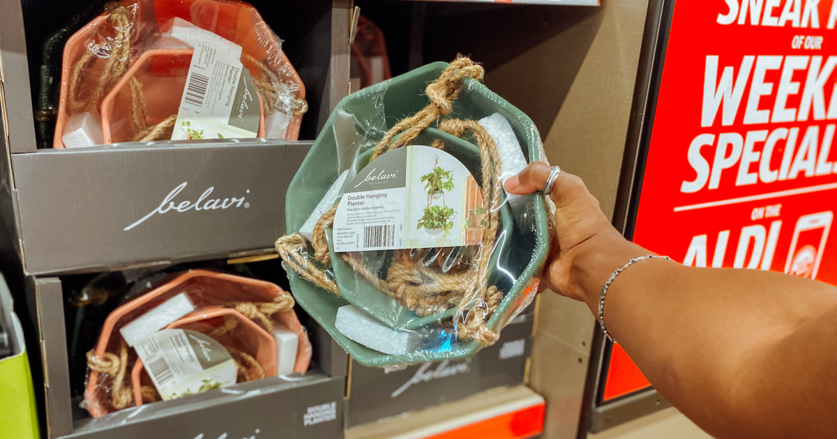 Hand grabbing a double hanging planter from in-store display