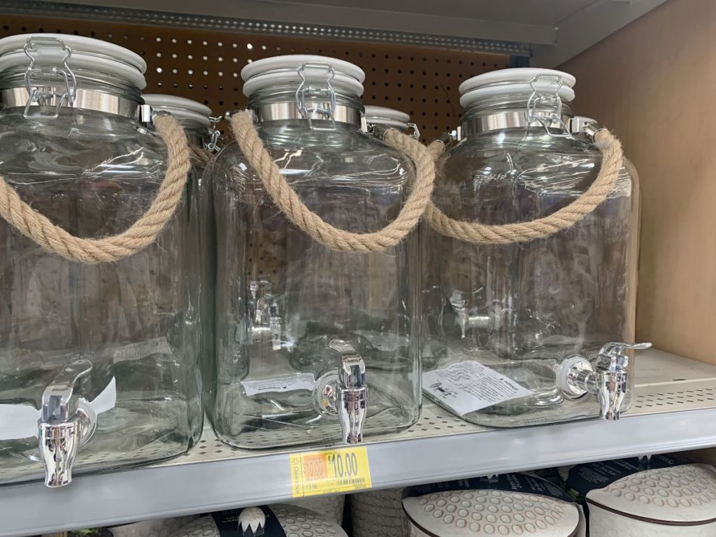 row of beverage dispensers on a shelf at Walmart