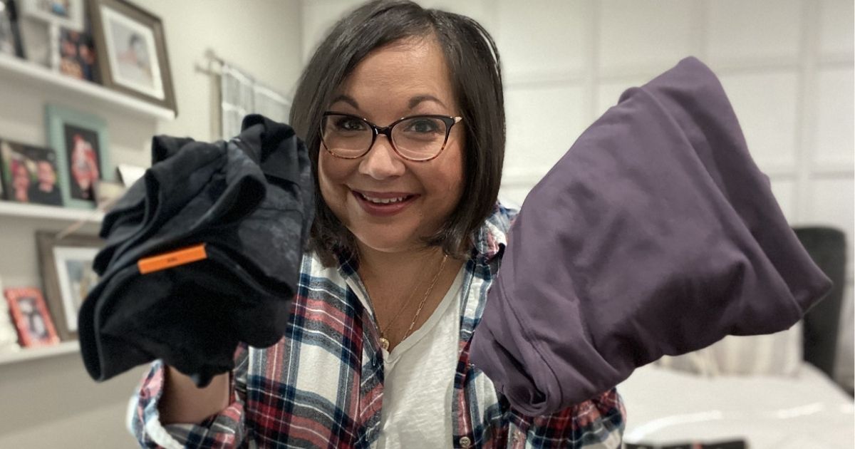 woman holding two pairs of Danskin Leggings