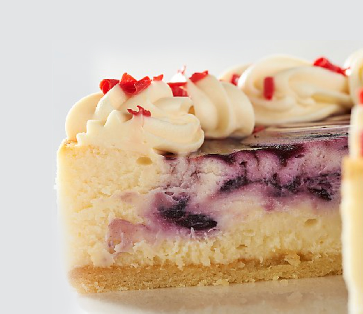 inside piece of a New York cheesecake with blueberry puree swirl