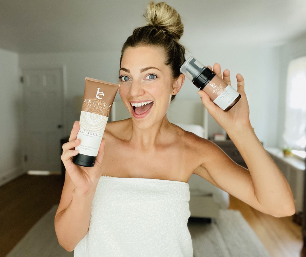woman holding up mousse and lotion self tanner