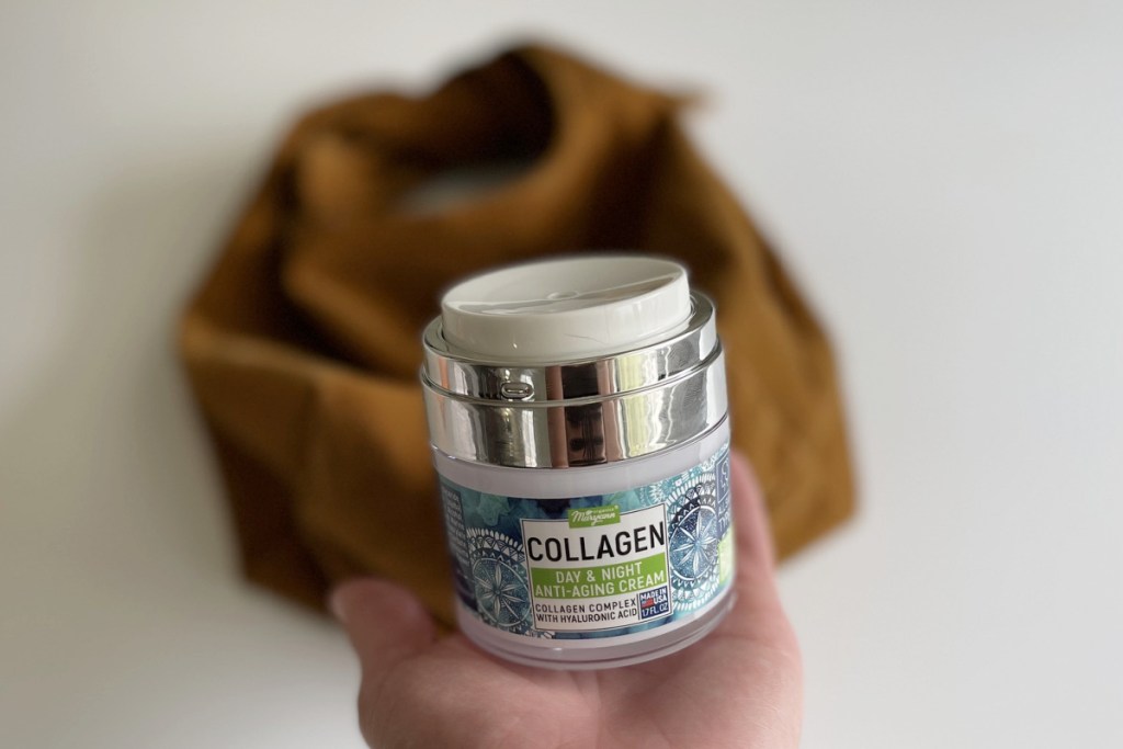 maryann organics collagen cream in hand above bag 