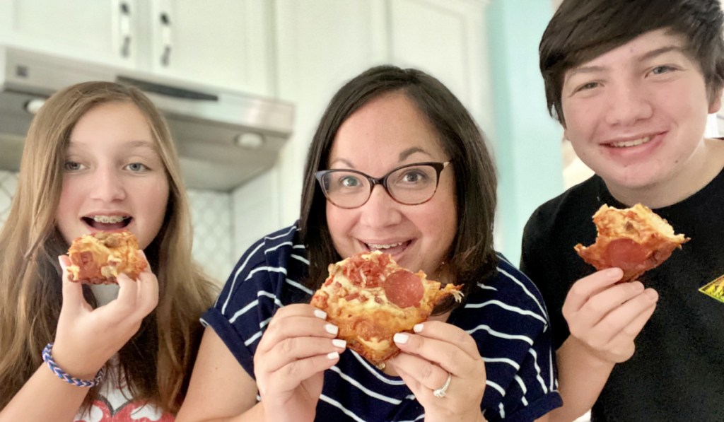 family eating motor city pizza