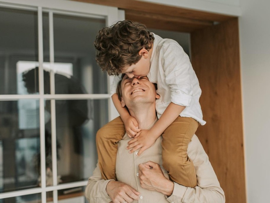 man with child on his shoulders