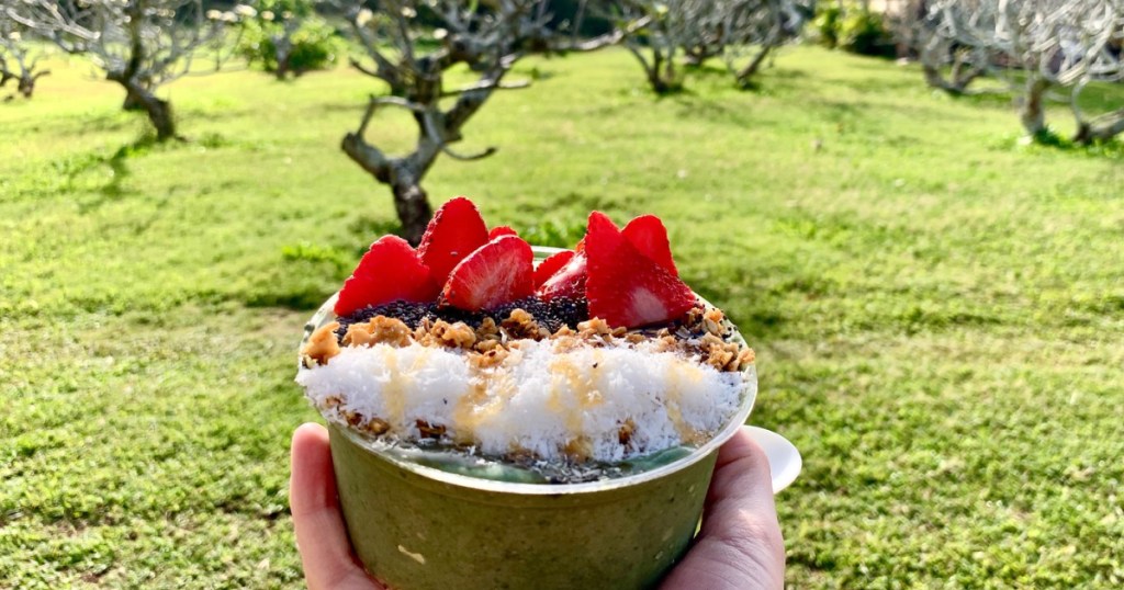 holding açaí bowl in Hawaii 