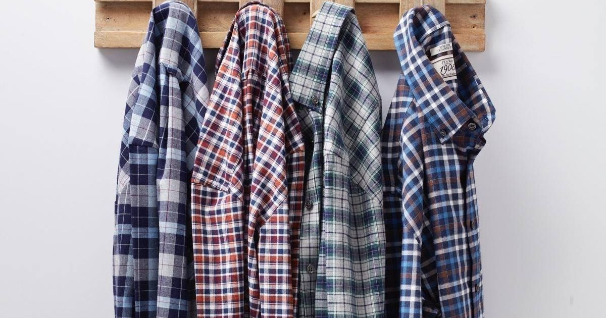 plaid shirts hanging on hooks