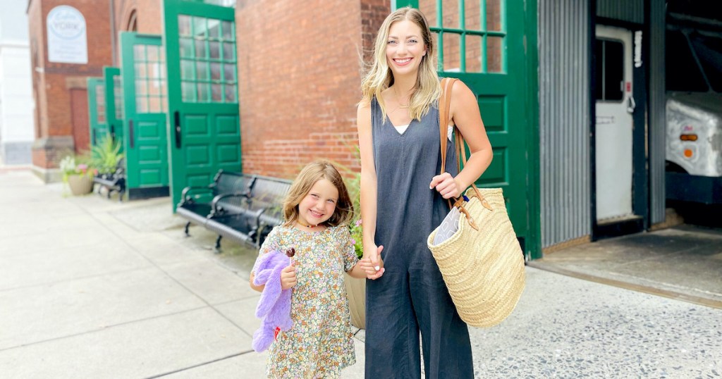 woman and girl holding hands in front of central farmers market