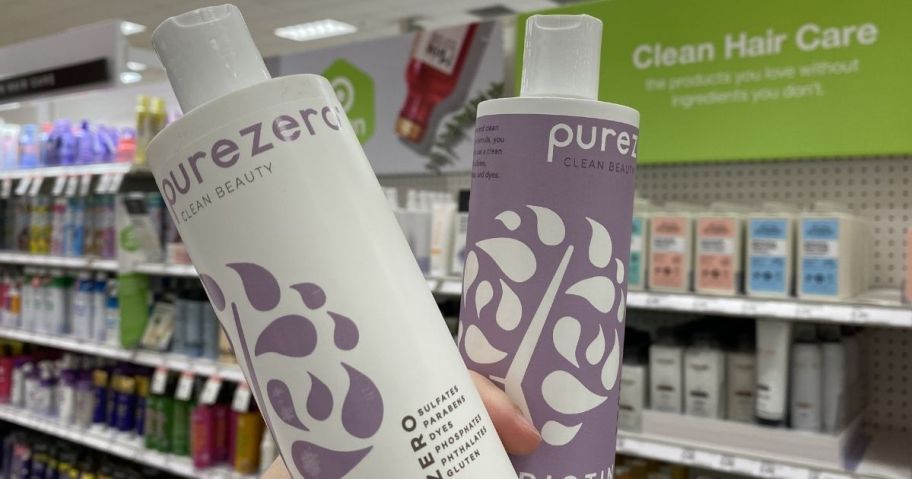 hand holding a bottle of shampoo and a conditioner