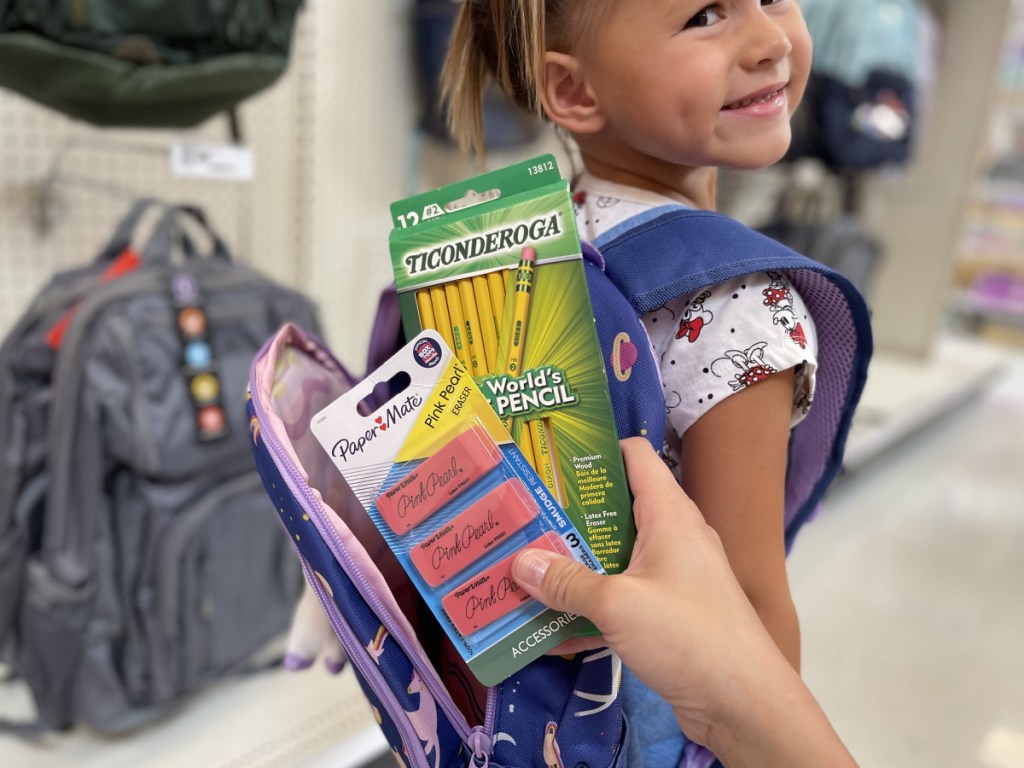 adding school supplies to backpack