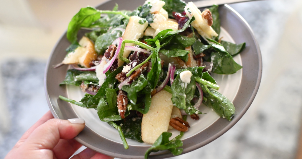 spinach pear salad with goat cheese on plate 