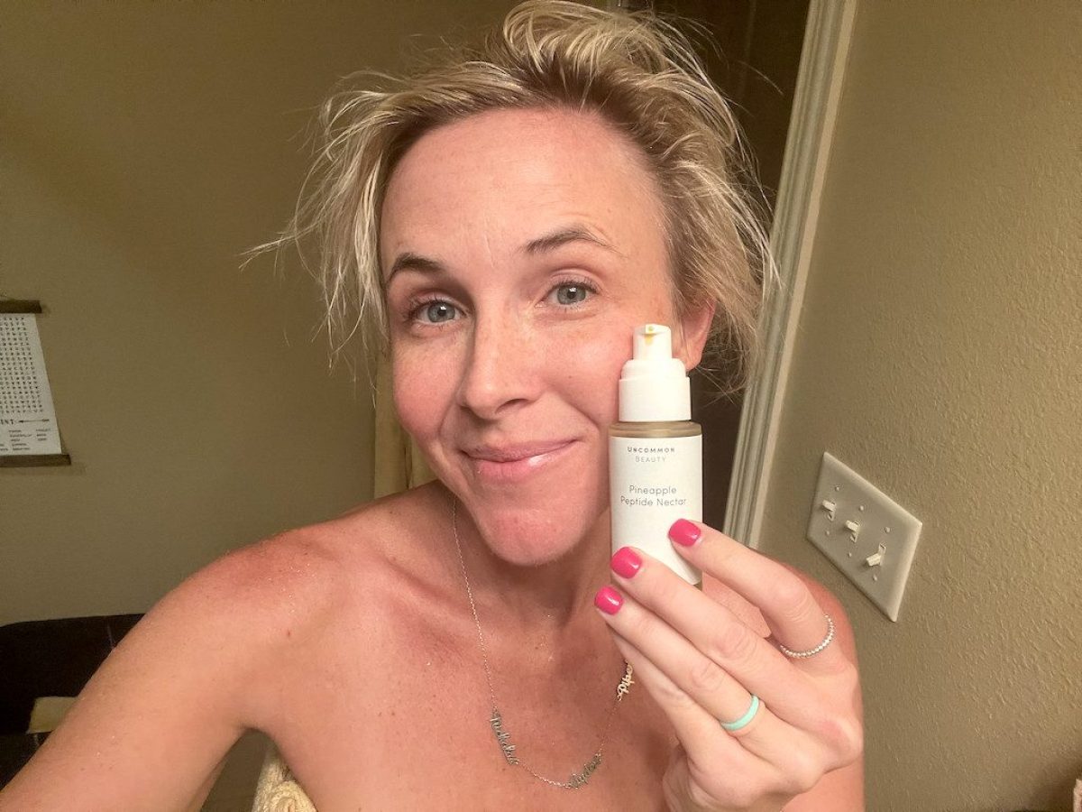 woman holding uncommon beauty serum