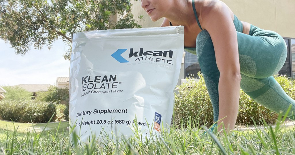 woman in grass with protein powder