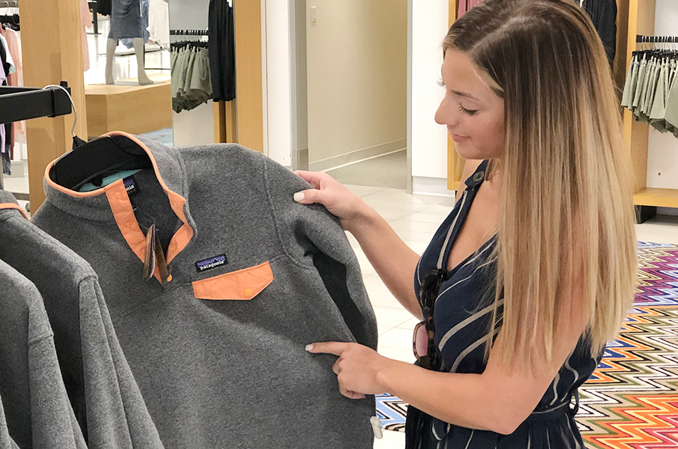 woman shopping patagonia jacket in nordstrom during anniversary sale