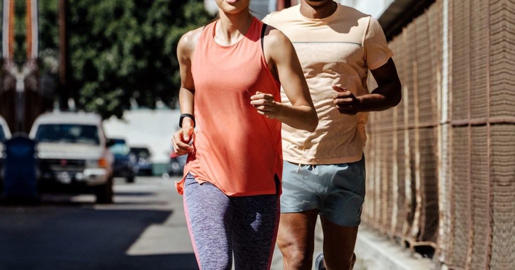 man and woman running wearing asics apparel