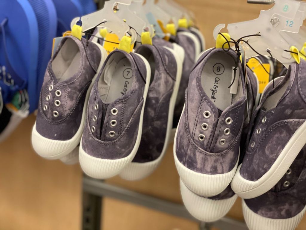 row of kids shoes on hangers