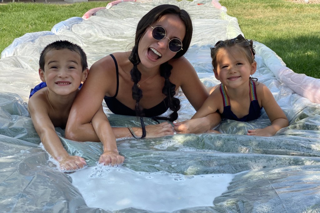 family sitting on DIY slip and slide