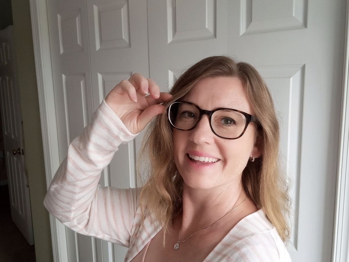 woman holding her glassesusa eyeglasses