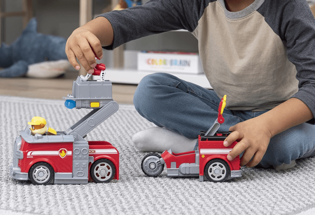 boy playing with a toy fire truck