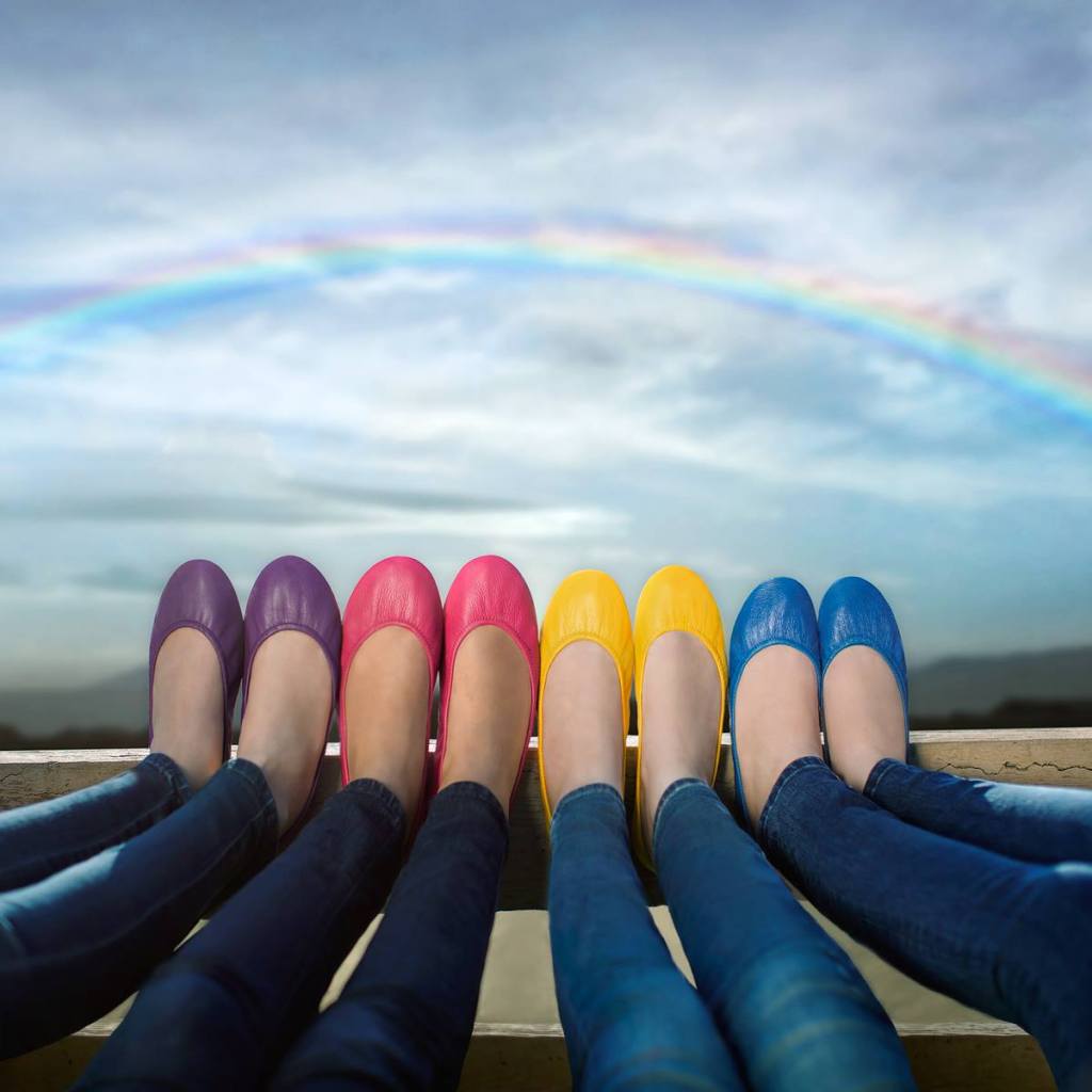 a row of women's feet with Tieks Flats