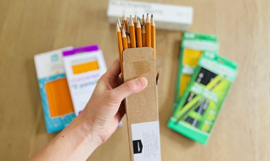 hand holding a box of wood pencils