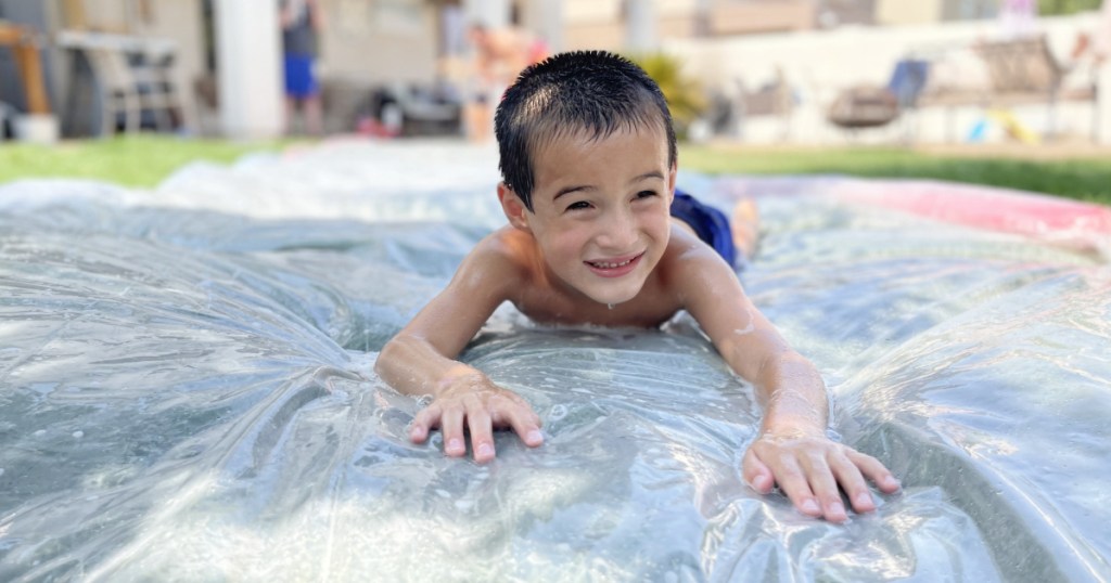 boy on DIY slip and slide