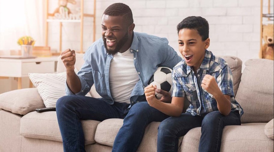 man and child watching TV