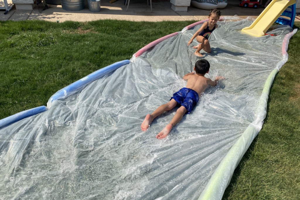 boy playing on huge DIY slip and slide