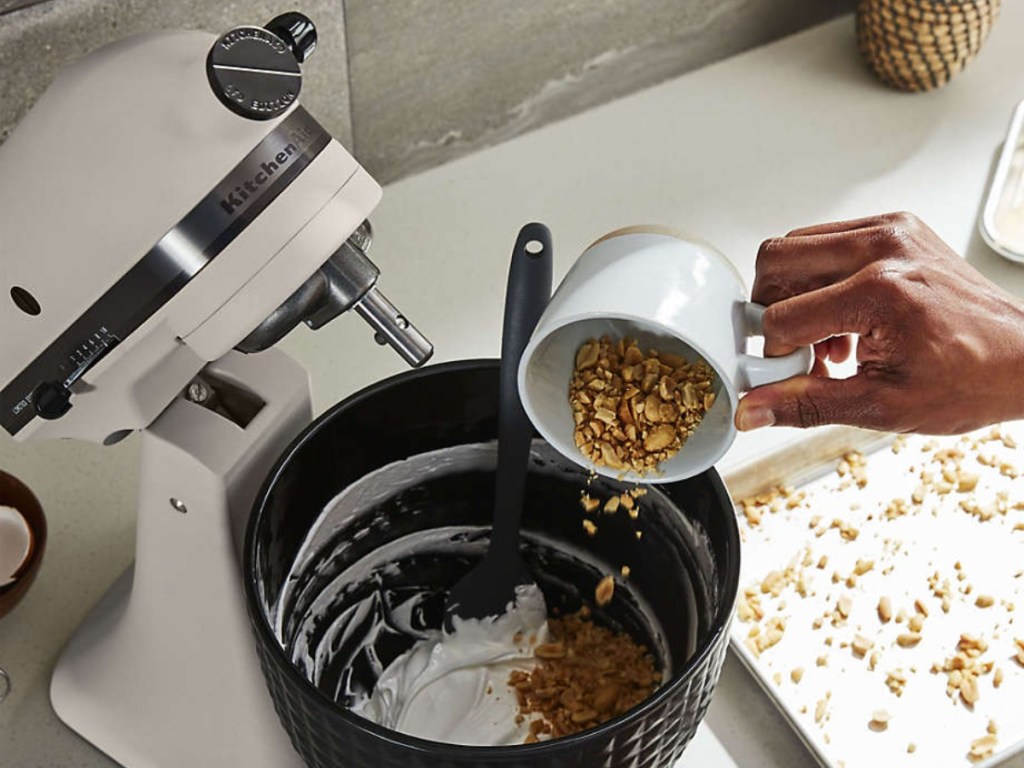 adding ingredients to black mixing bowl