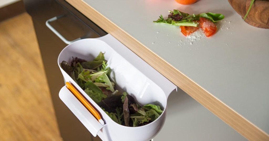 scrap trap attached to kitchen drawer with debris inside