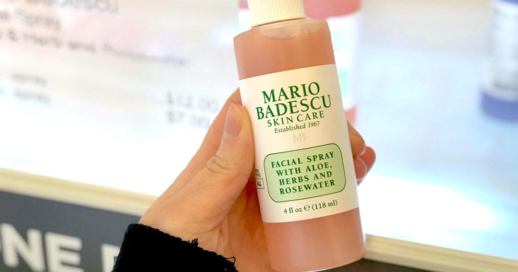 hand holding a bottle of mario badescu facial spray