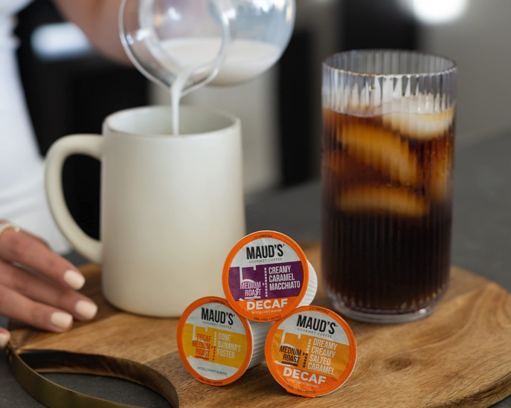 maud's decaf coffee pods next to coffee w/ milk