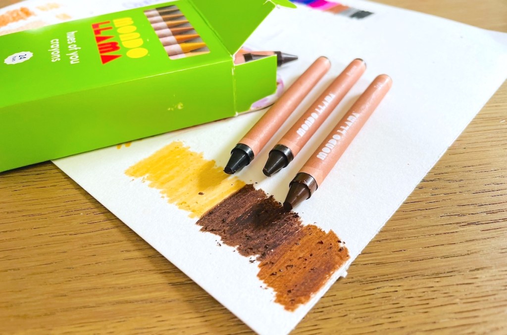 brown mondo llama crayons on white paper with green box