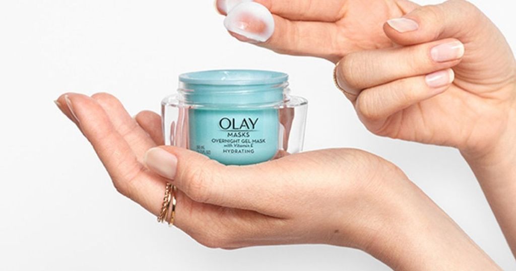 hand dipping into jar of olay mask