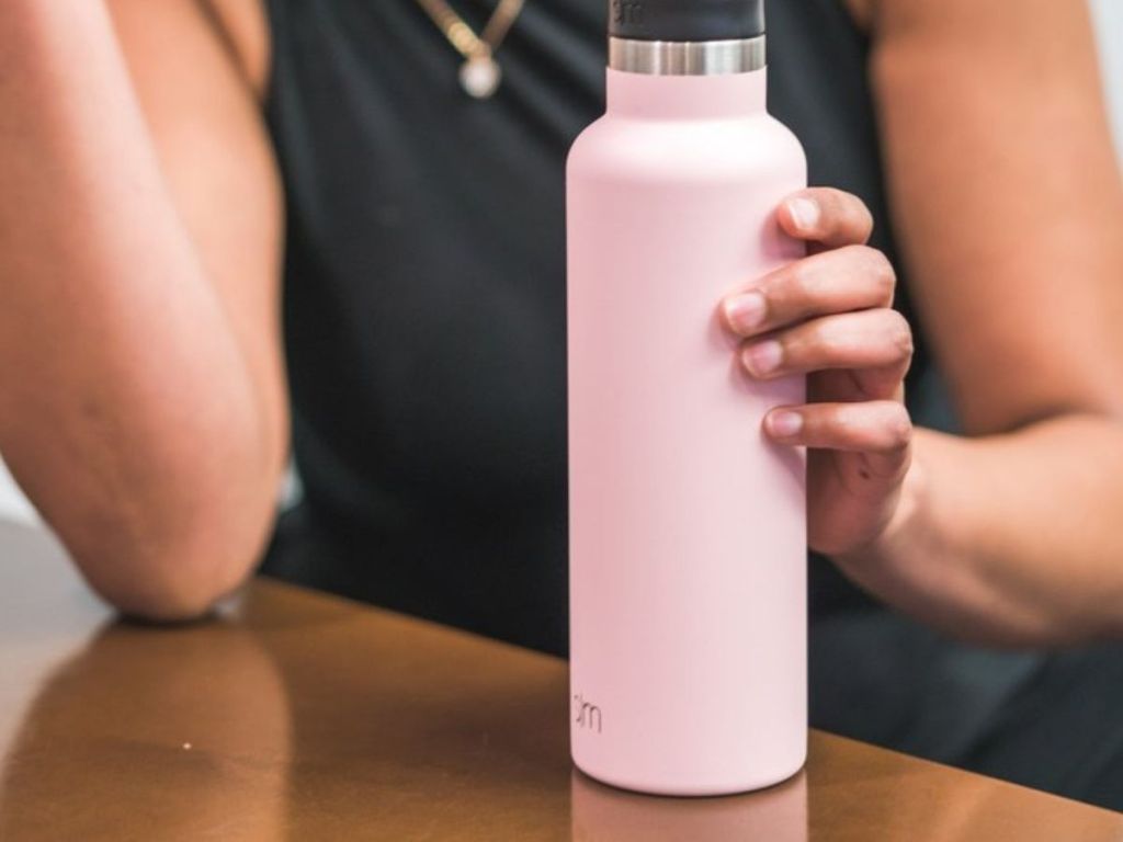 woman holding pink water bottle