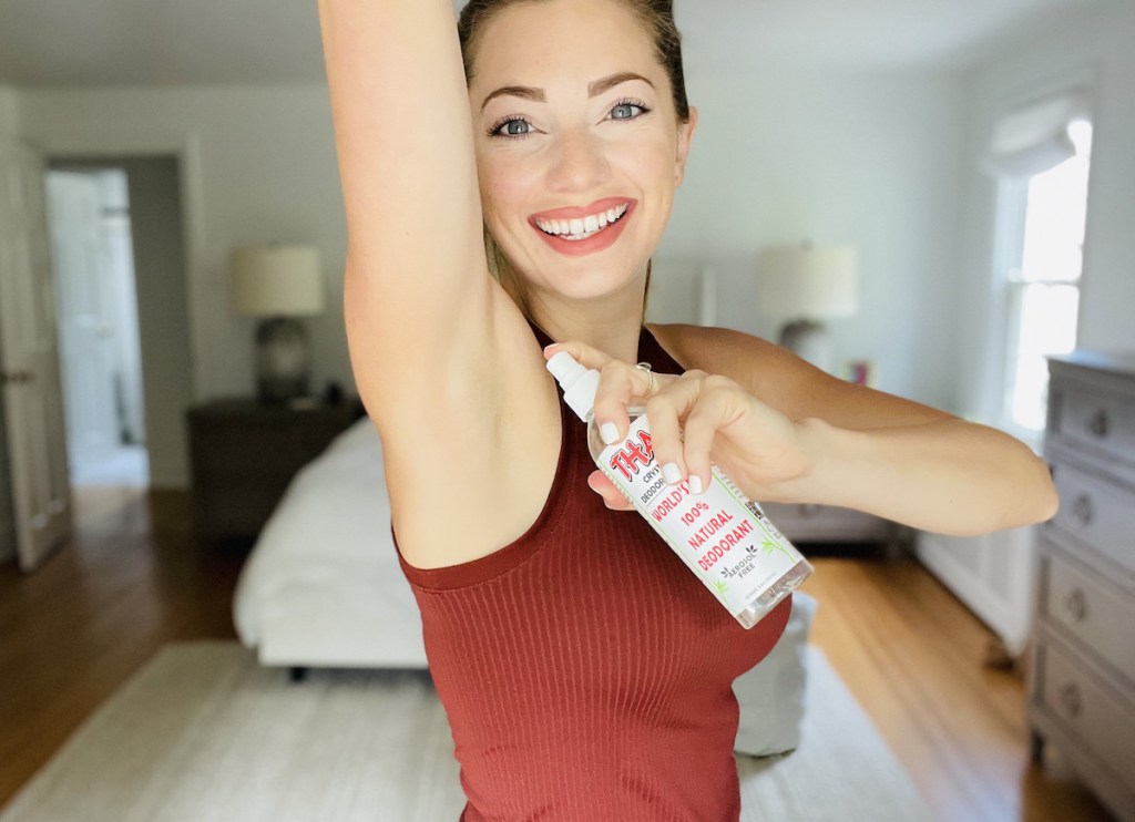 woman spraying thai crystal deodorant underarm