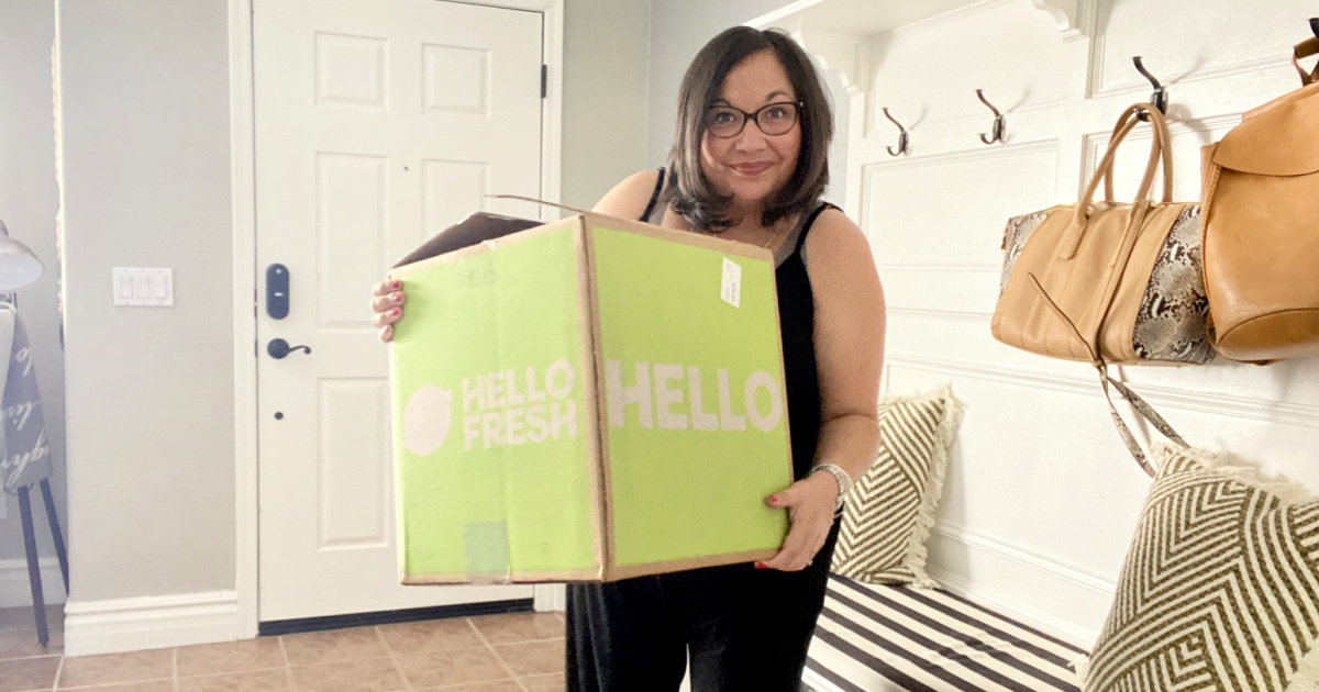 woman holding box of hellofresh meals