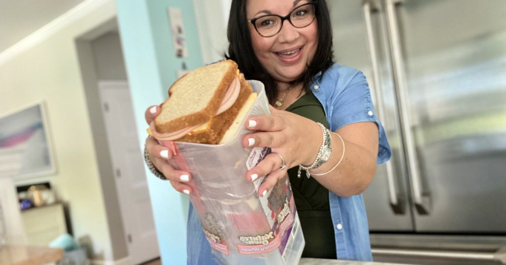 woman holding sandwich dispenser