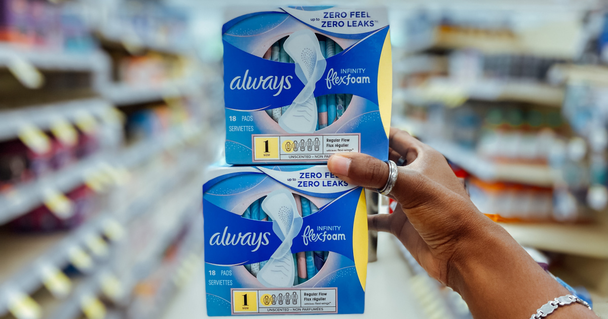 hand holding two packs of always infinity pads in store