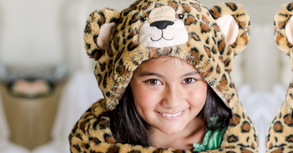 girl wearing a hooded leopard cape