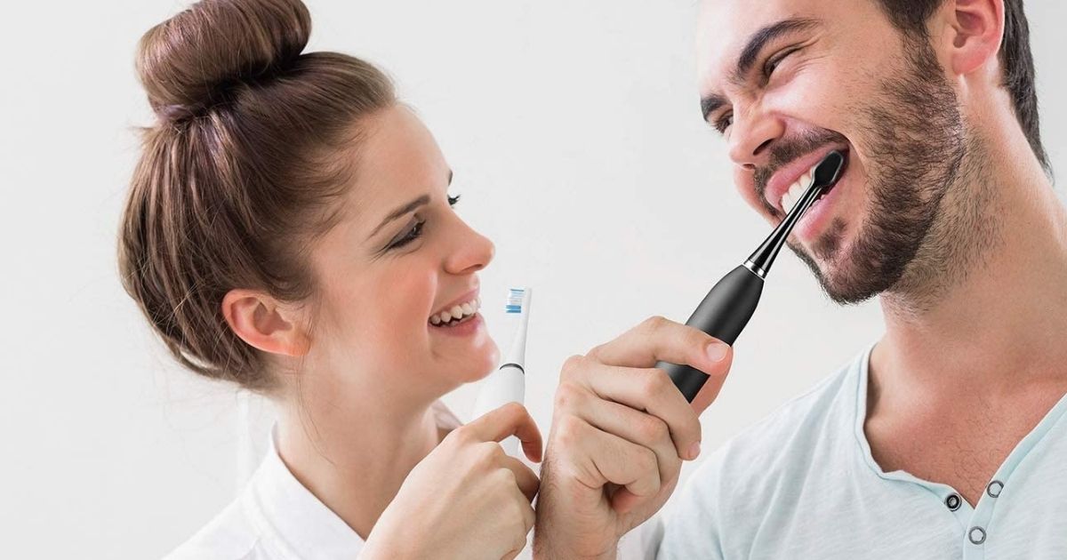 two people brushing their teeth